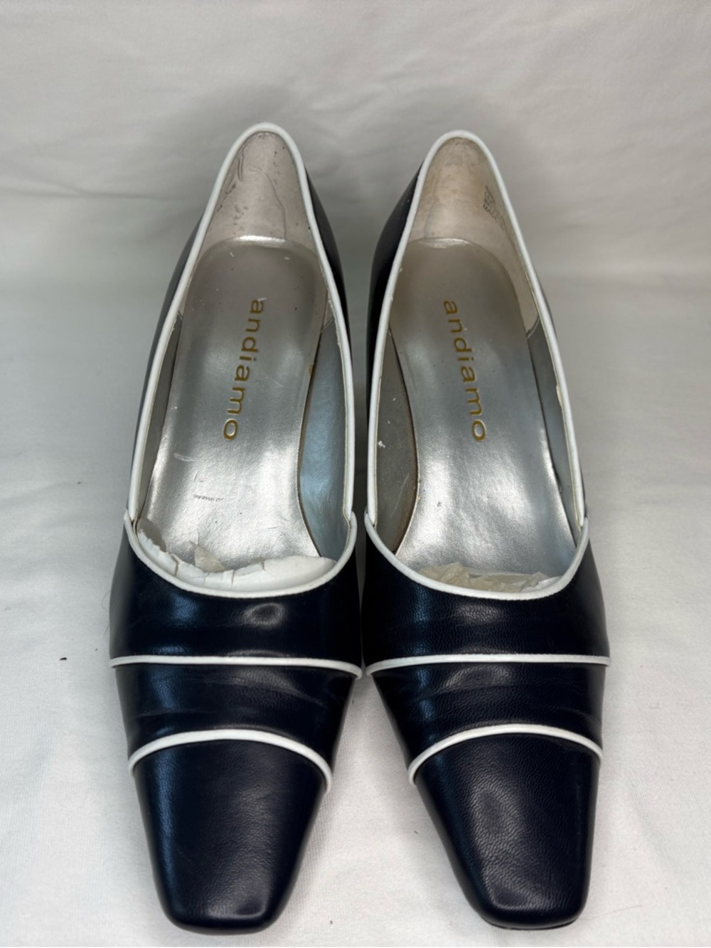 Andiamo Black Leather Pointed Toe Pumps with White Trim
